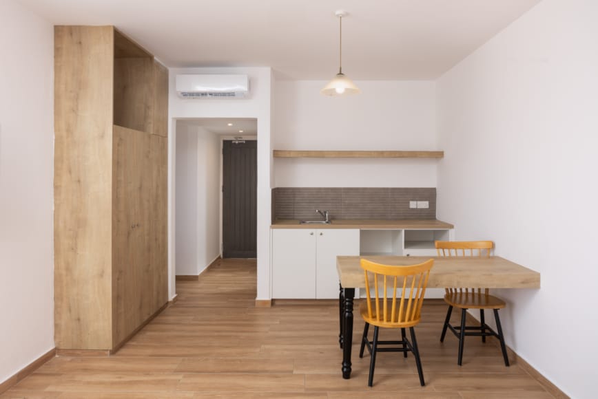 a kitchen with a table and chairs
