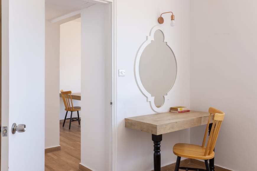 a room with a table and a mirror