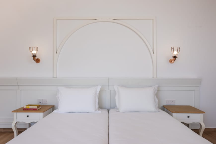a room with white beds