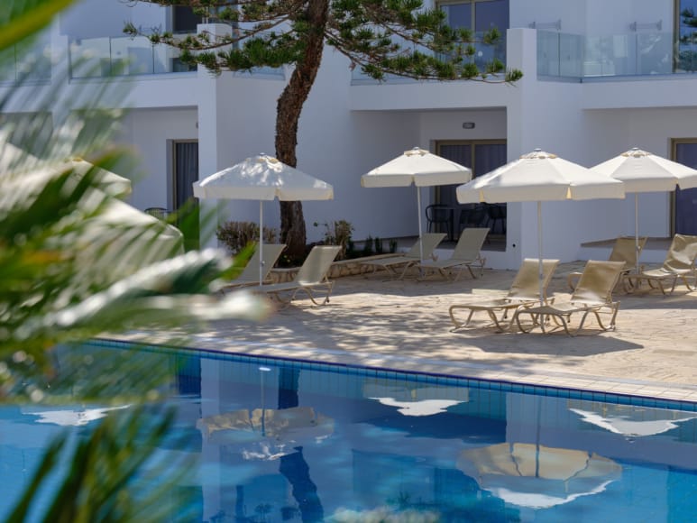 a pool with umbrellas and chairs