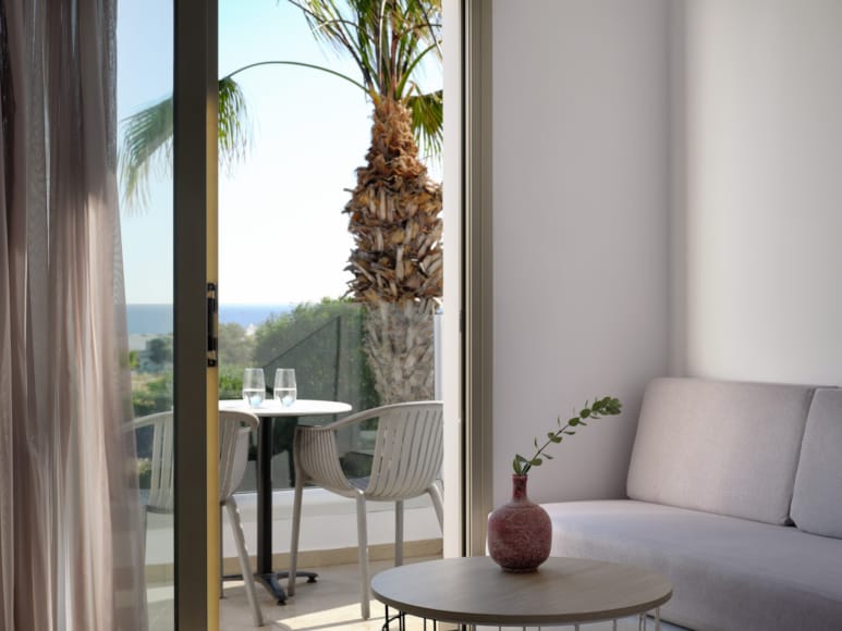 a living room with a table and chairs