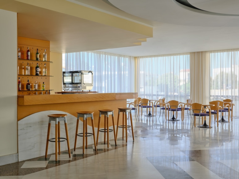 a room with a bar and stools