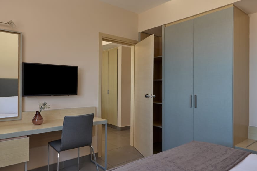 a room with a desk and a tv