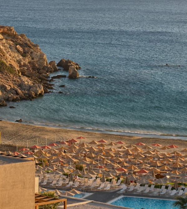 a beach with a pool and rocks