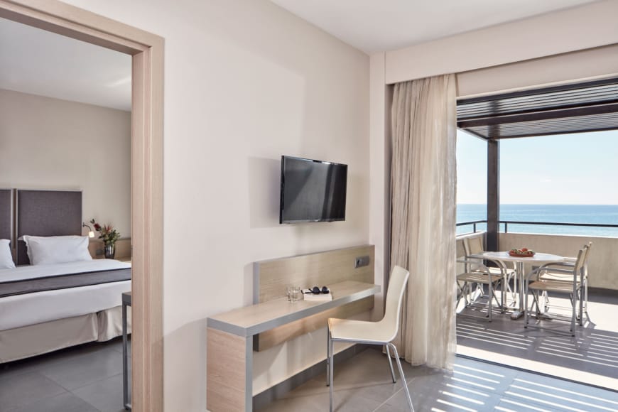 a room with a tv and chairs