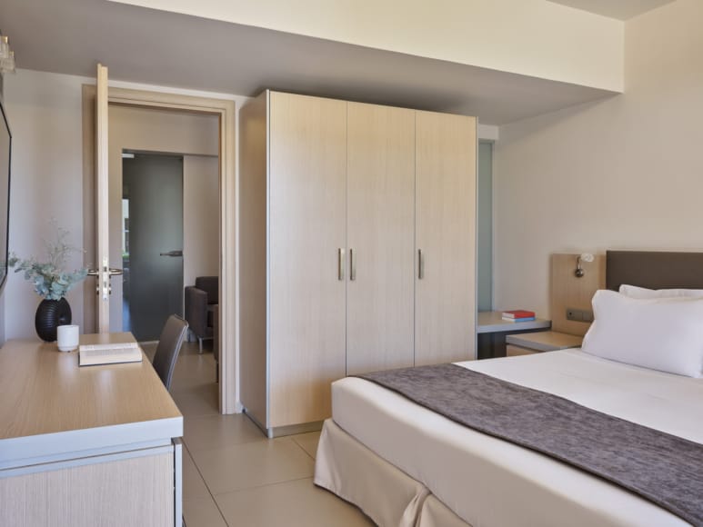 a hotel room with a bed and desk