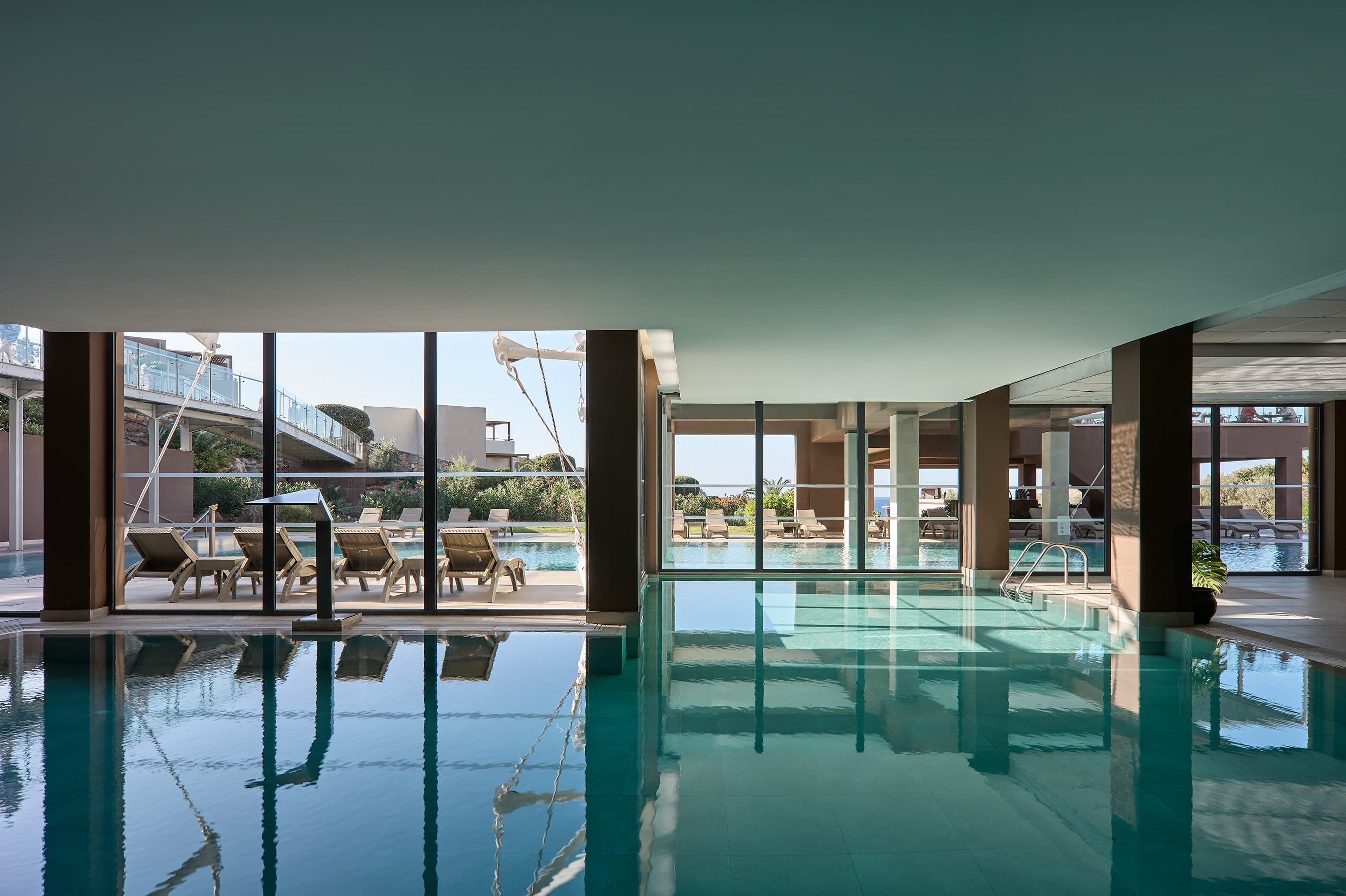 a pool with a deck and chairs