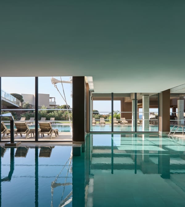 a pool with a deck and chairs