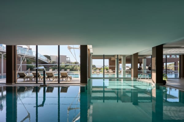 a pool with a deck and chairs