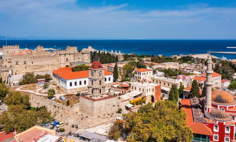 a city with red roofs by the water