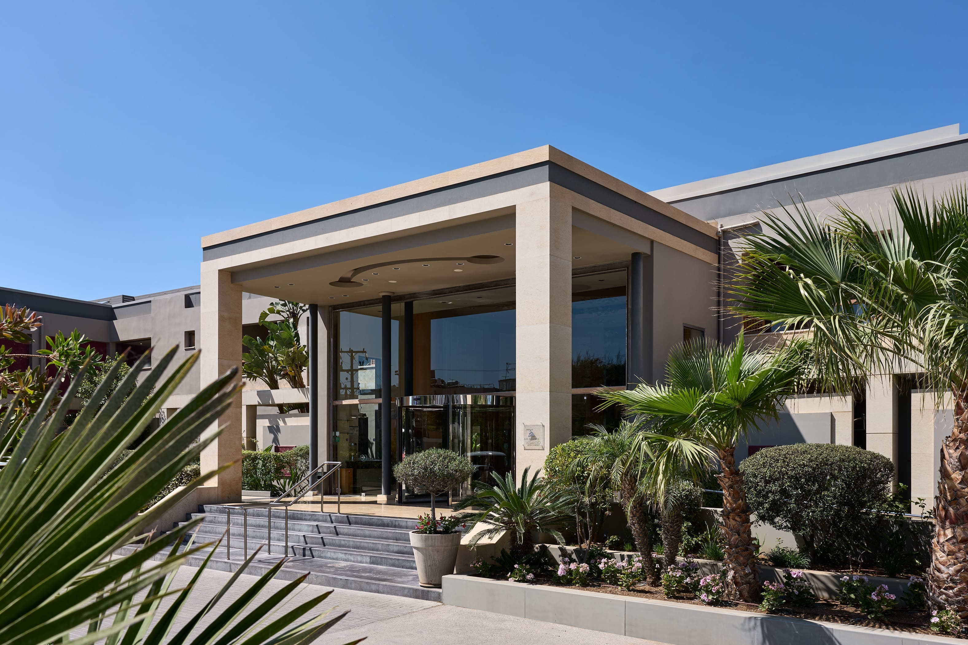 a building with a staircase and palm trees