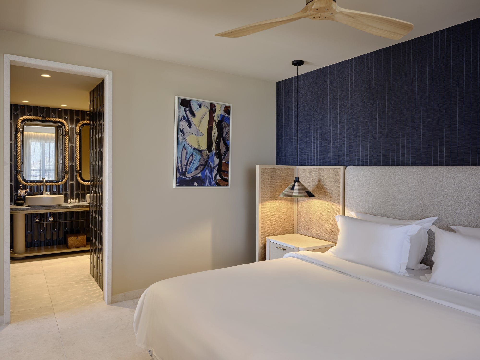 a bedroom with a large bed and a large poster on the wall