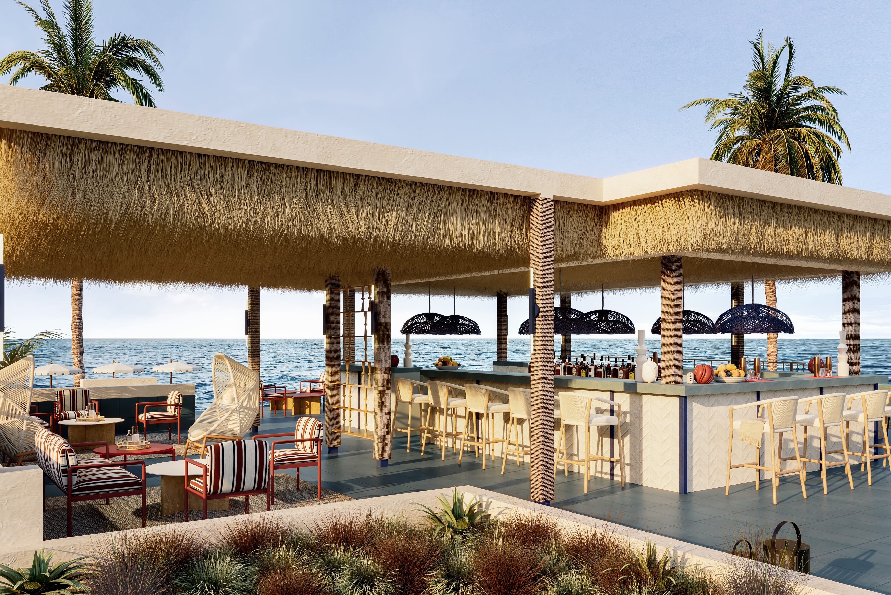 a patio with chairs and umbrellas by a beach