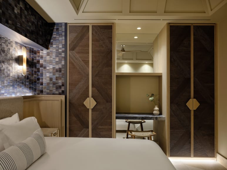 a bedroom with a large mirror