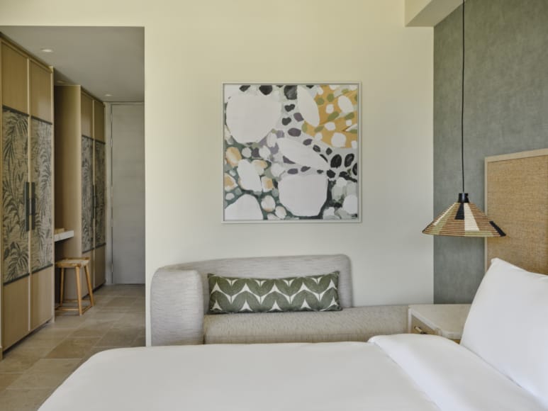 a room with a couch and a painting on the wall