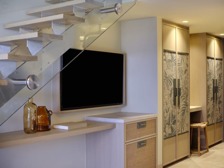 a room with a tv and cabinets