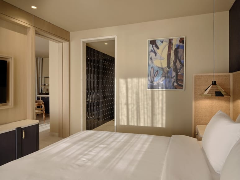 a bedroom with a bed and a desk