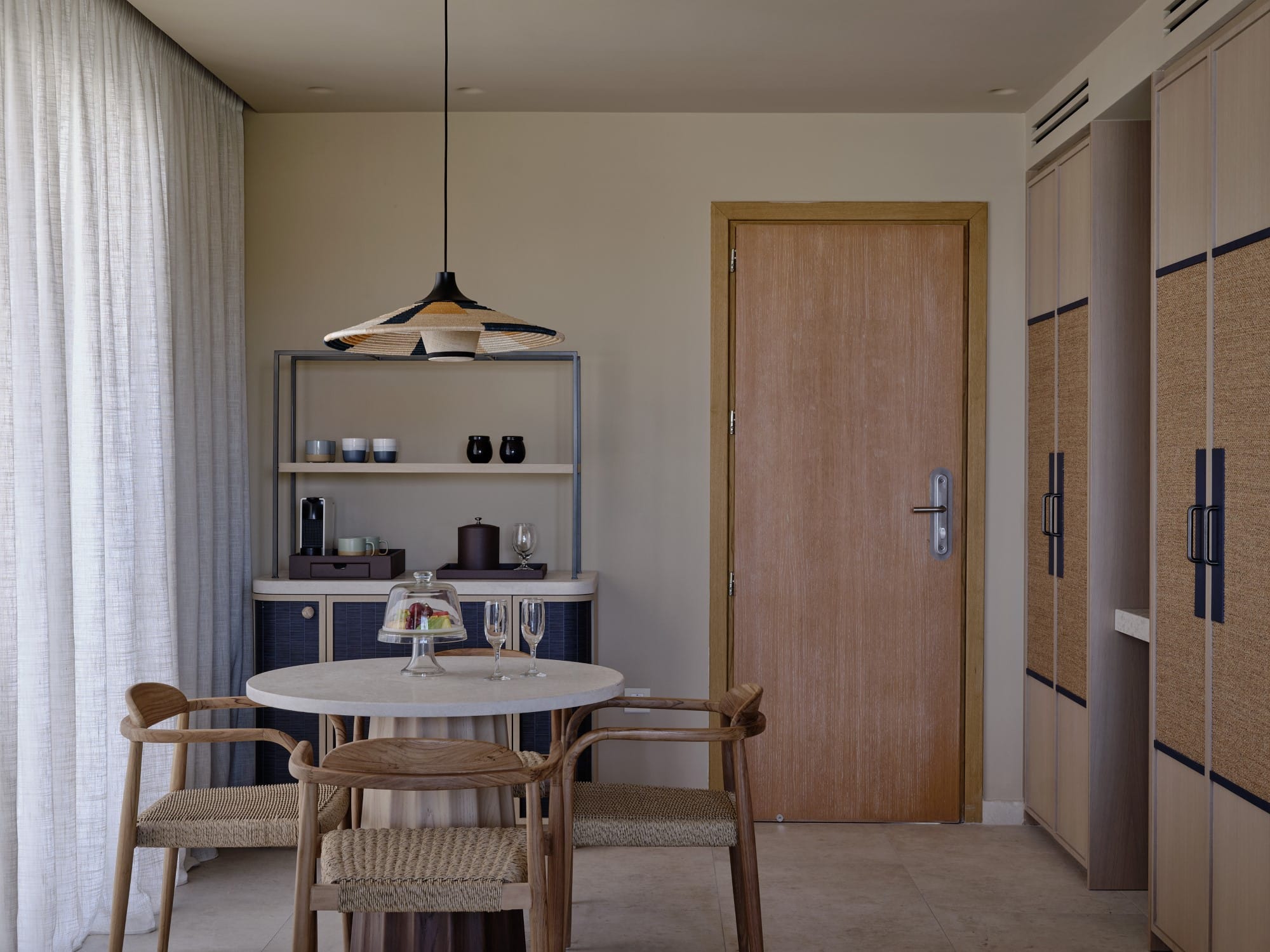 a dining room with a table and chairs