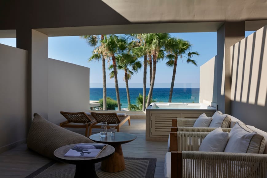 a living room with a view of the ocean
