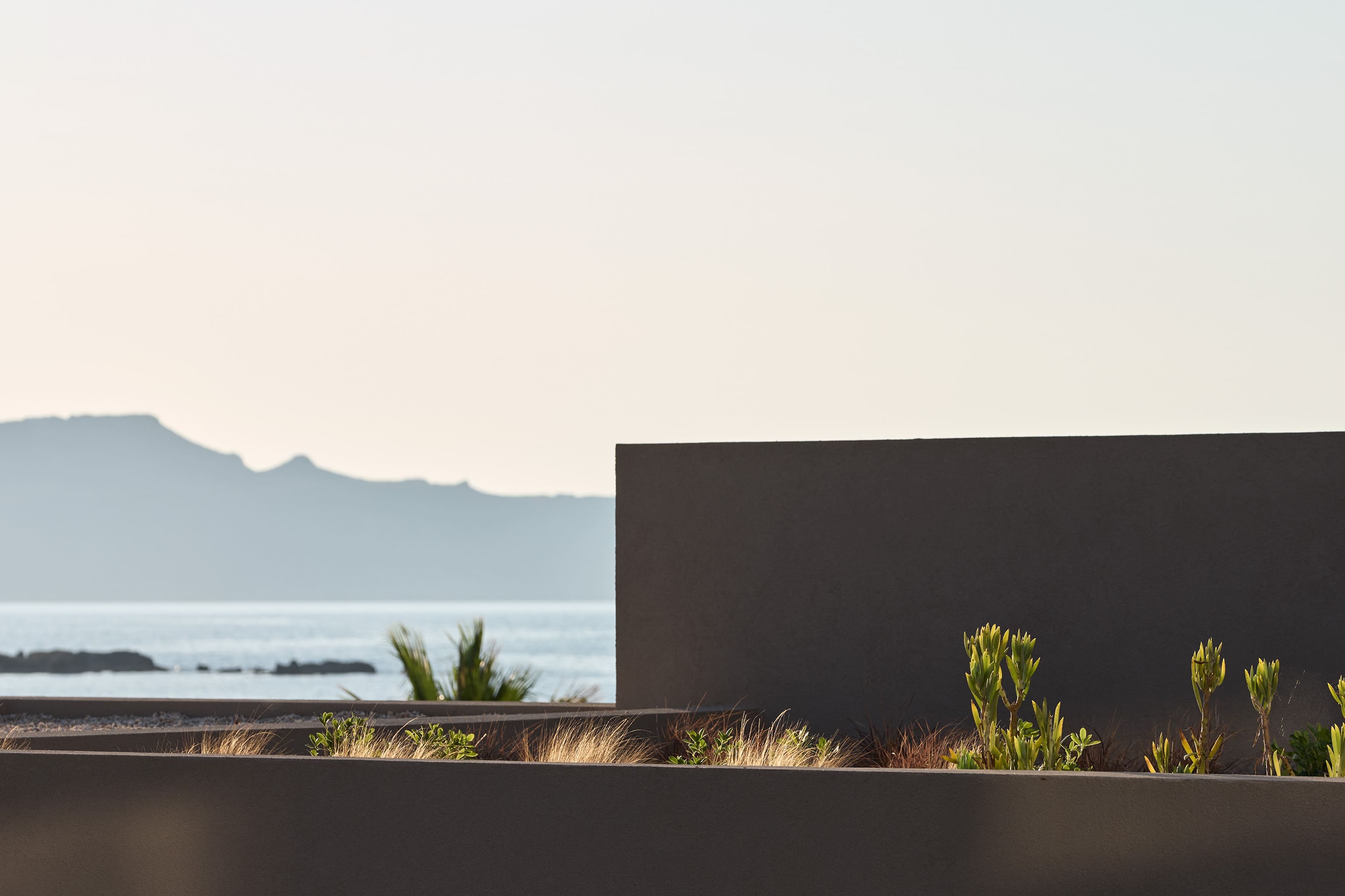 a view of the ocean and mountains