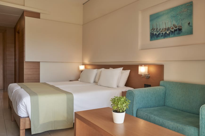 a room with a bed and couches