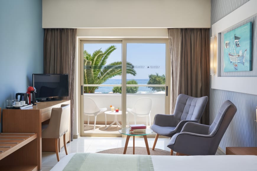 a living room with a view of the ocean