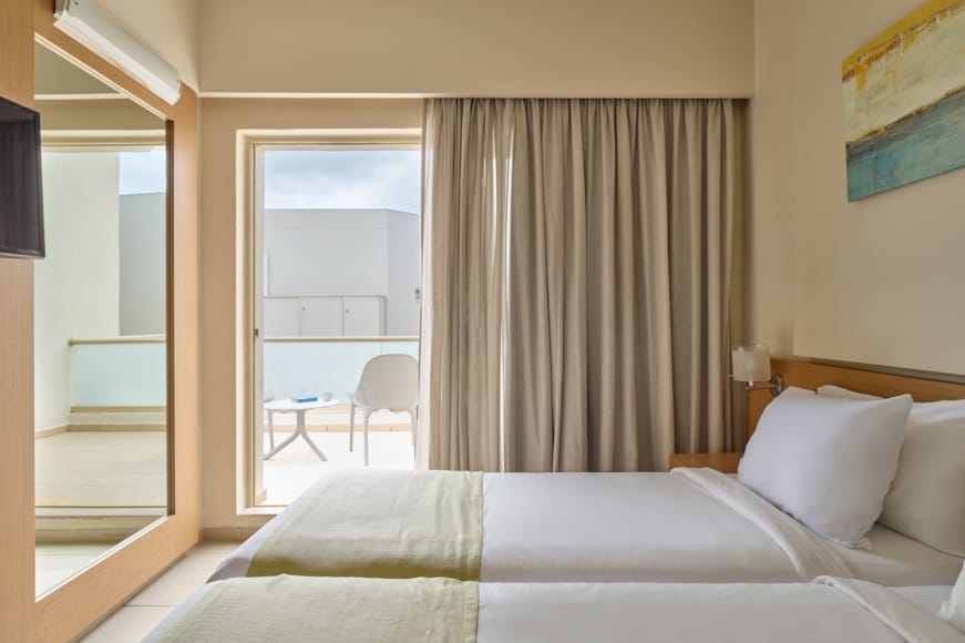 a bedroom with a bed and chairs