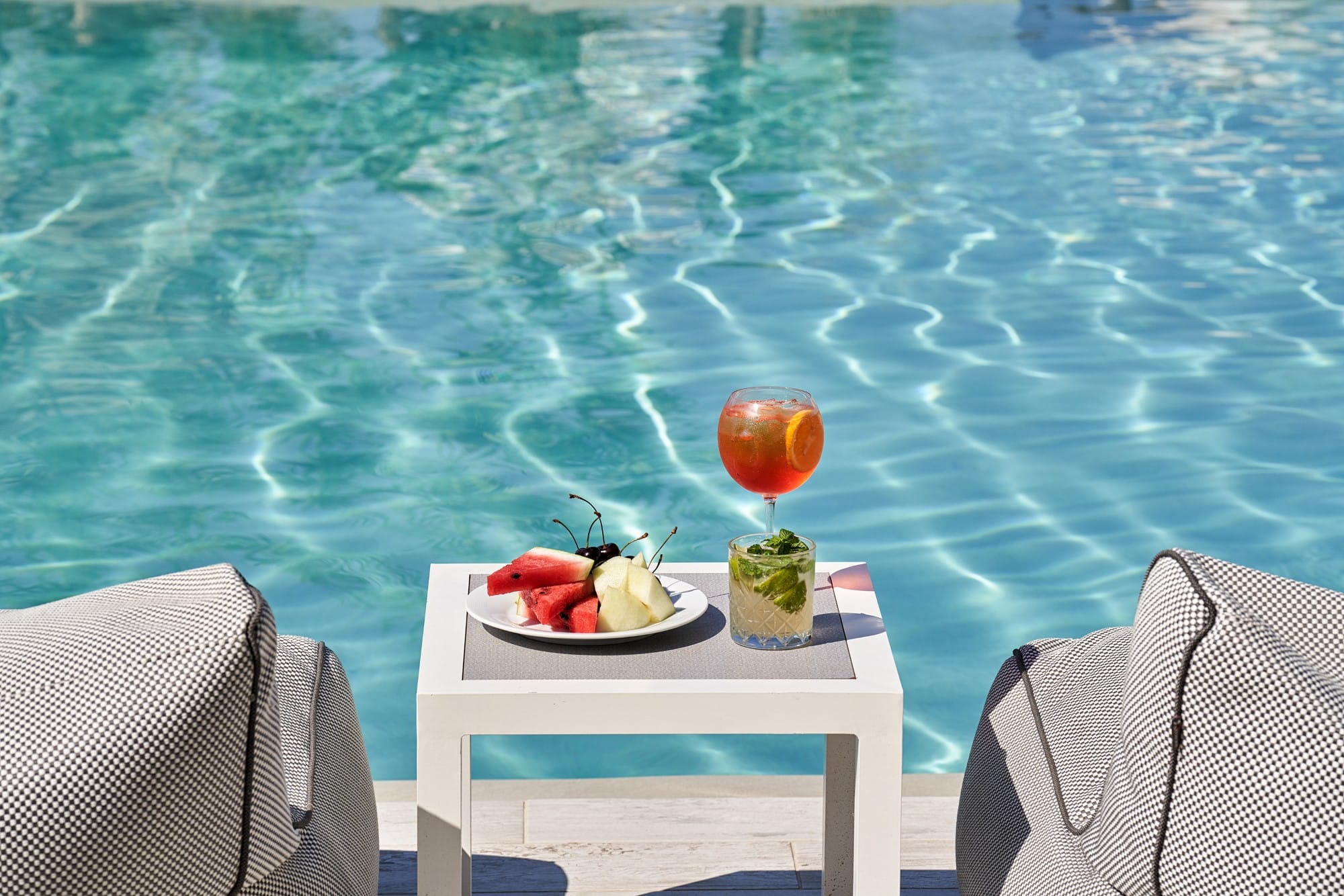 a table with food and a body of water in the background