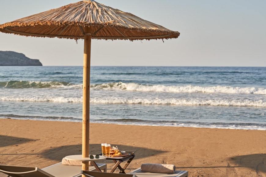 a table and umbrella on a beach