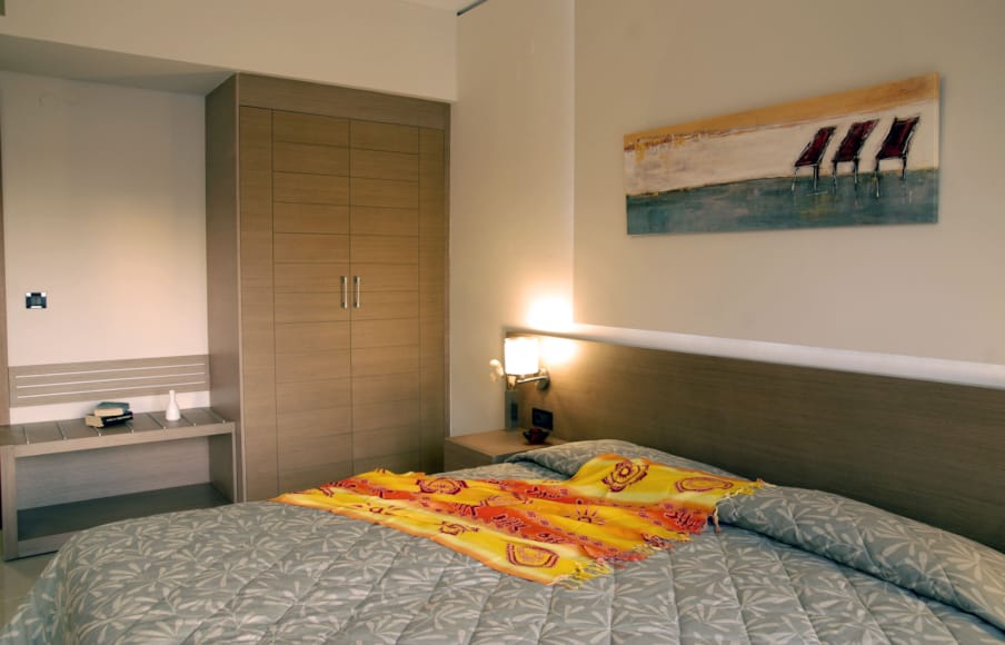 a bedroom with a bed and a desk