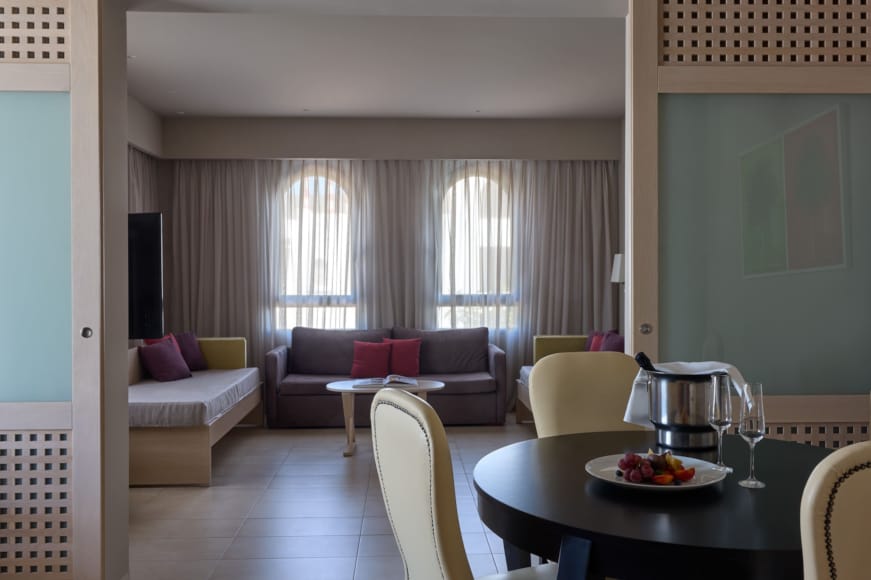 a living room with a table and chairs