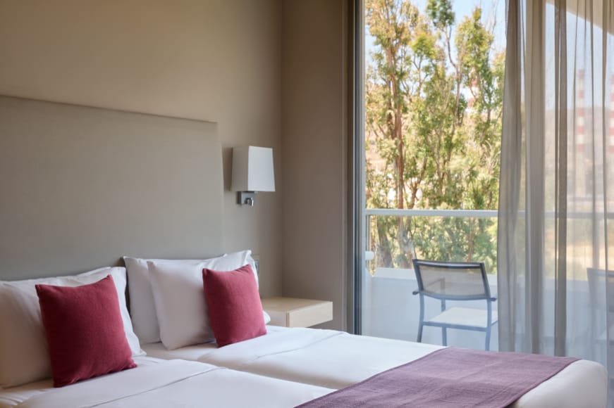 a bed with red pillows