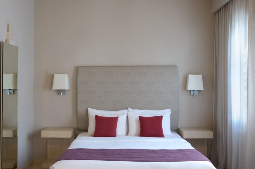 a bed with red pillows