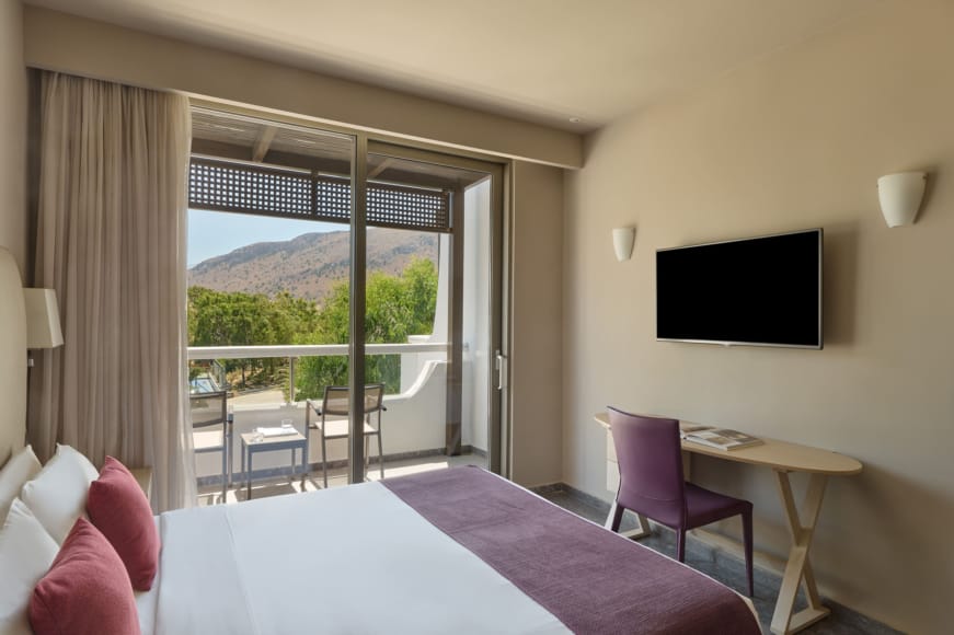 a room with a tv and chairs