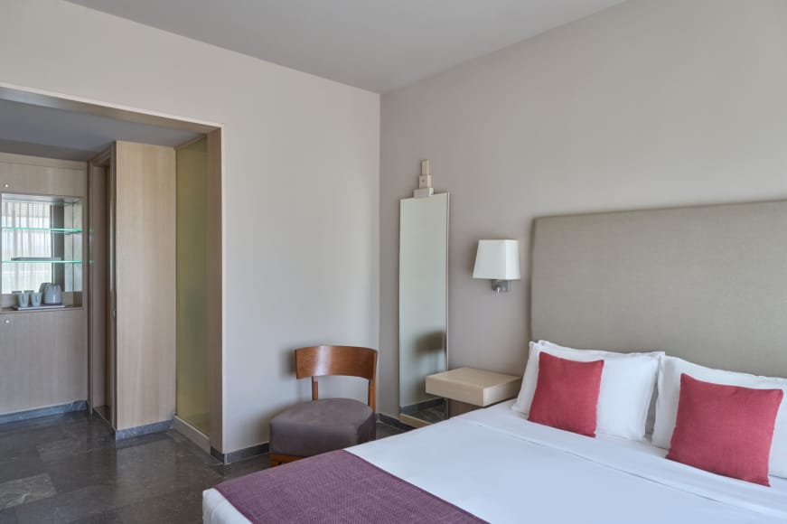 a bedroom with a bed and a chair