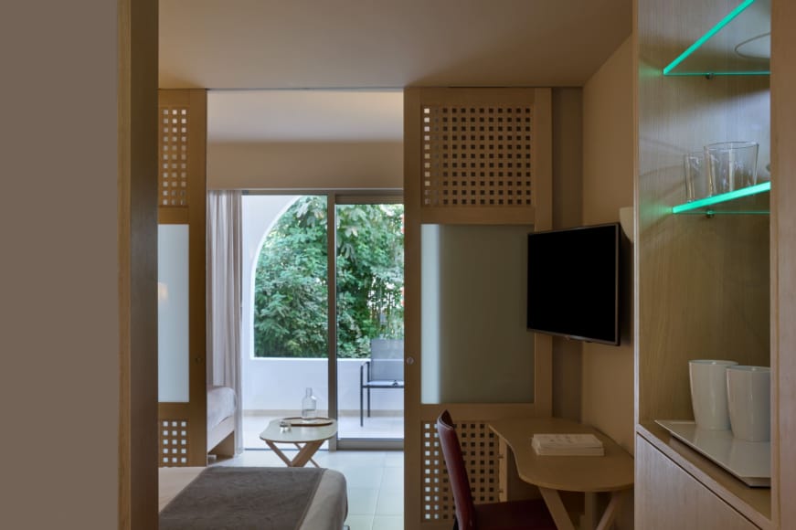 a living room with a tv and chairs