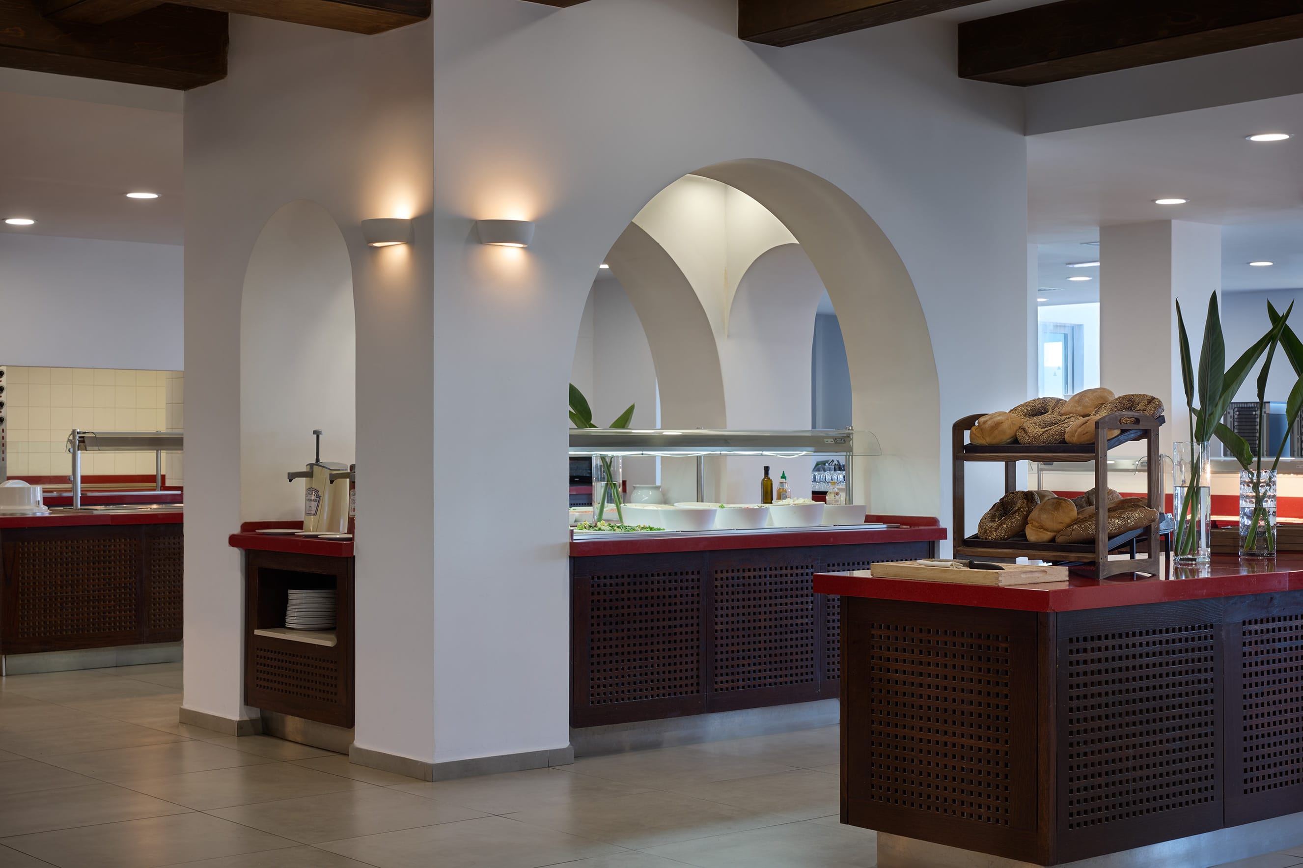 a kitchen with a large arched window