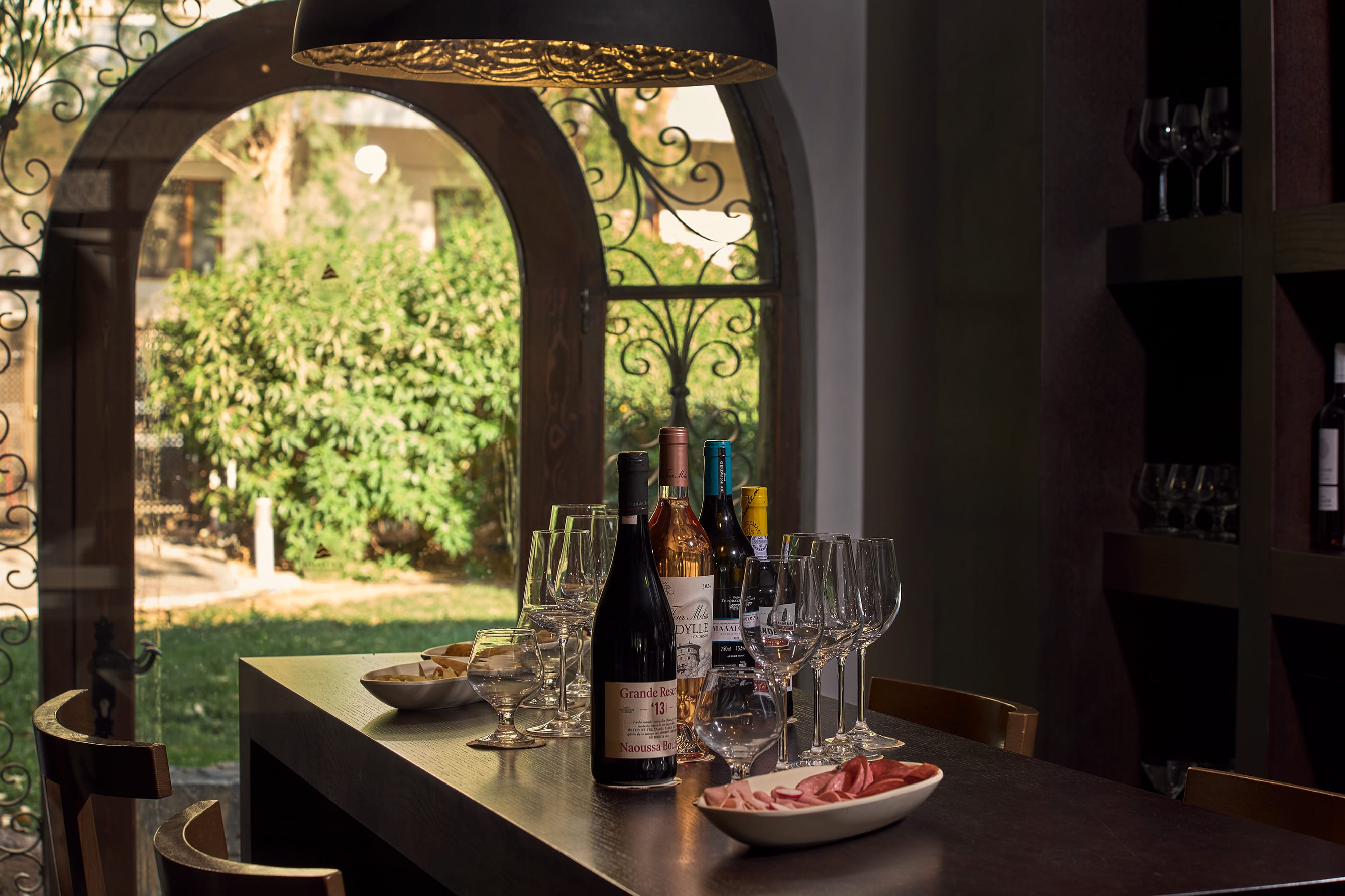 a table with wine bottles and glasses