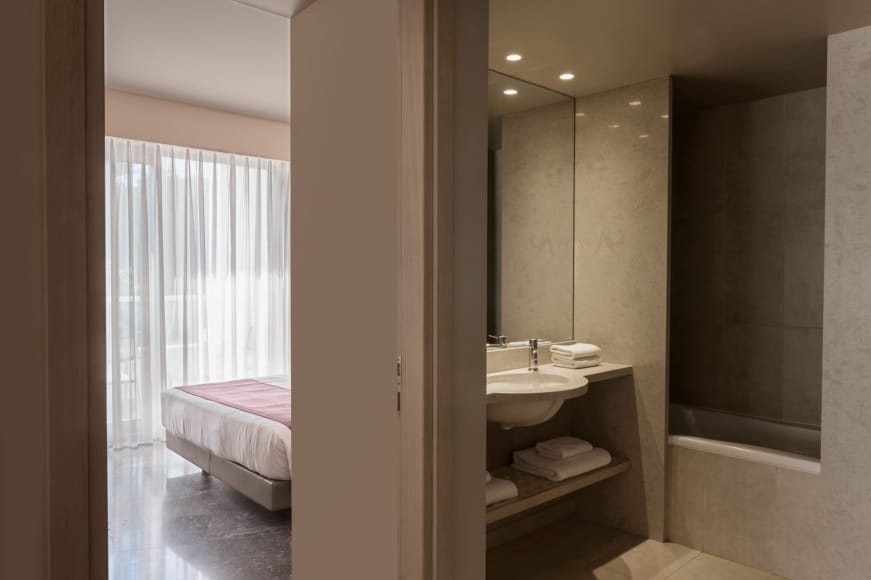 a bathroom with a bed and sink