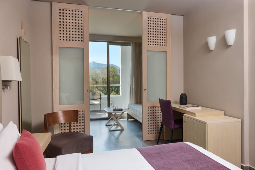 a room with a desk and chairs