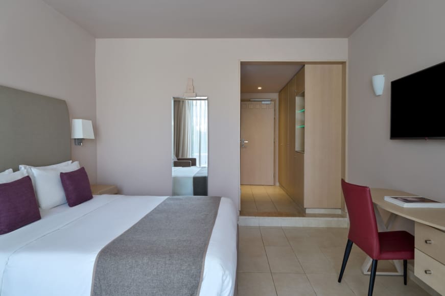 a bedroom with a bed and a desk