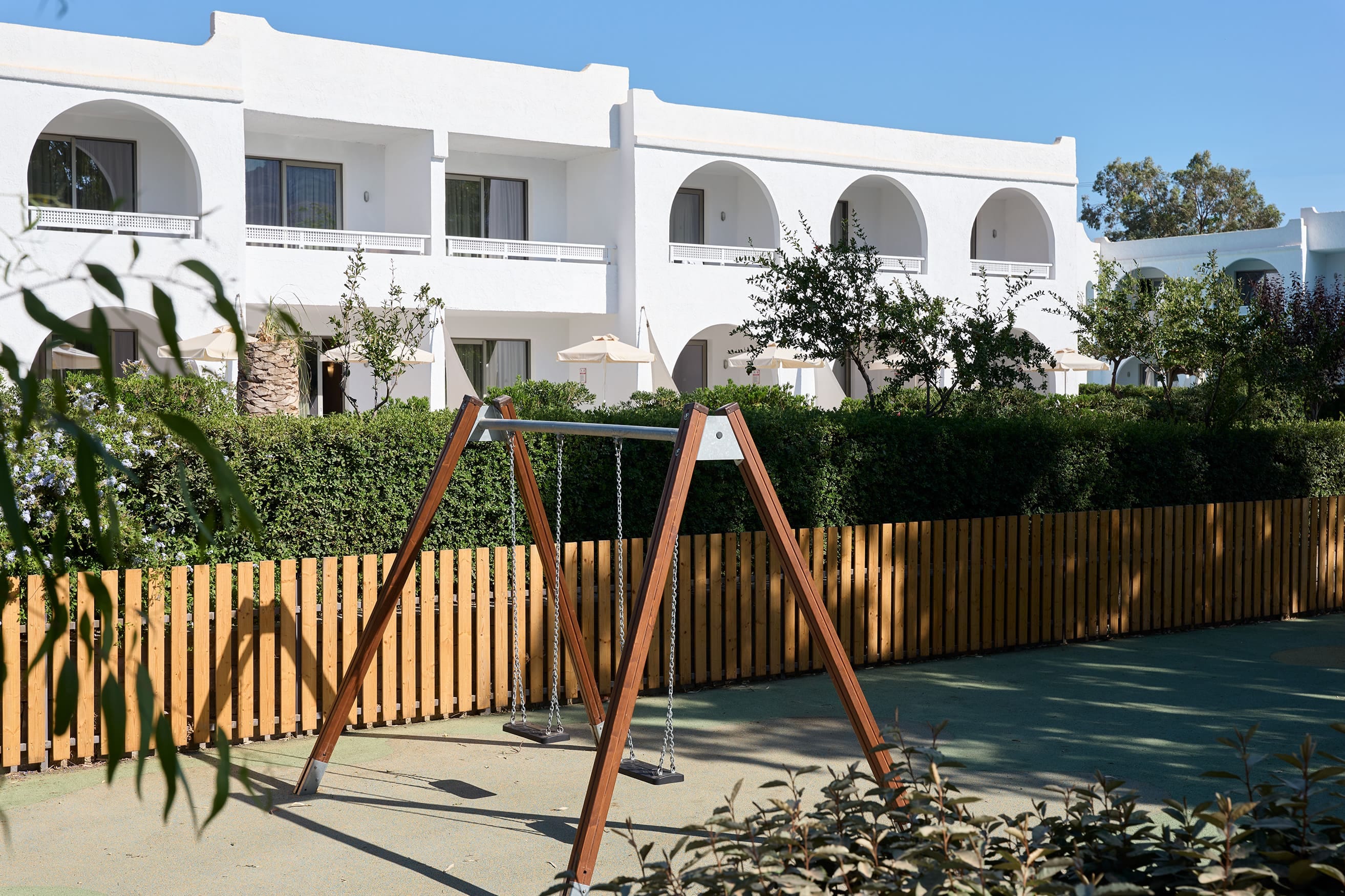 a fenced in yard with a building in the background