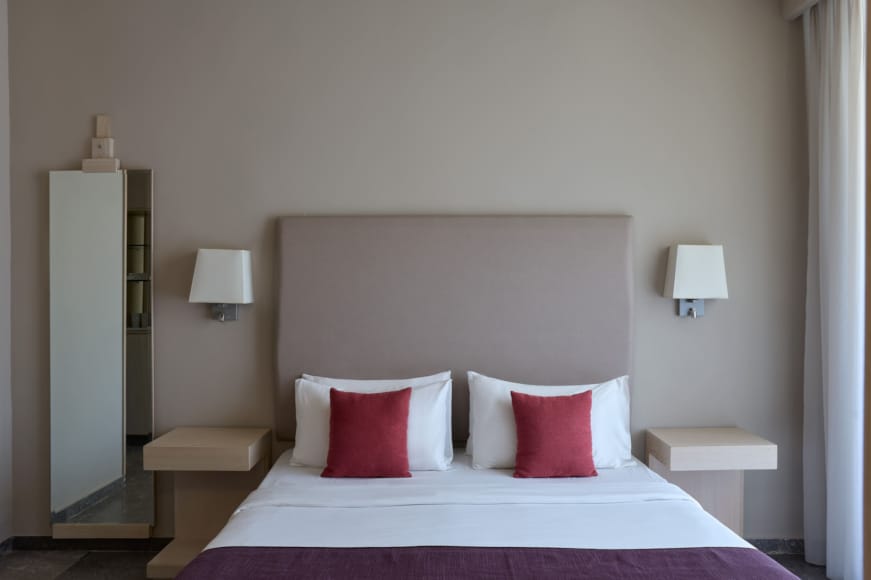 a bed with red pillows