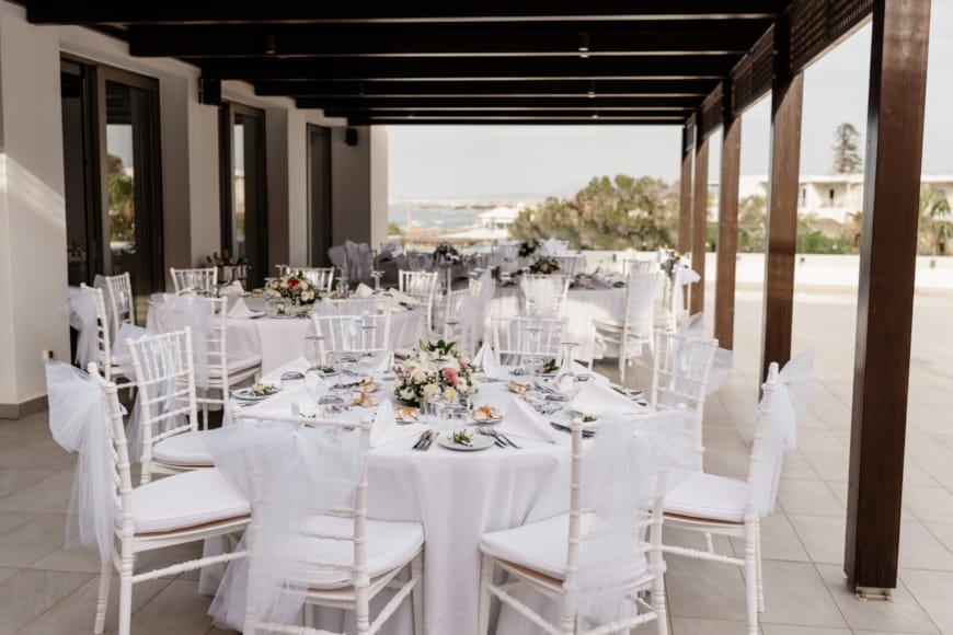 a dining table with white chairs