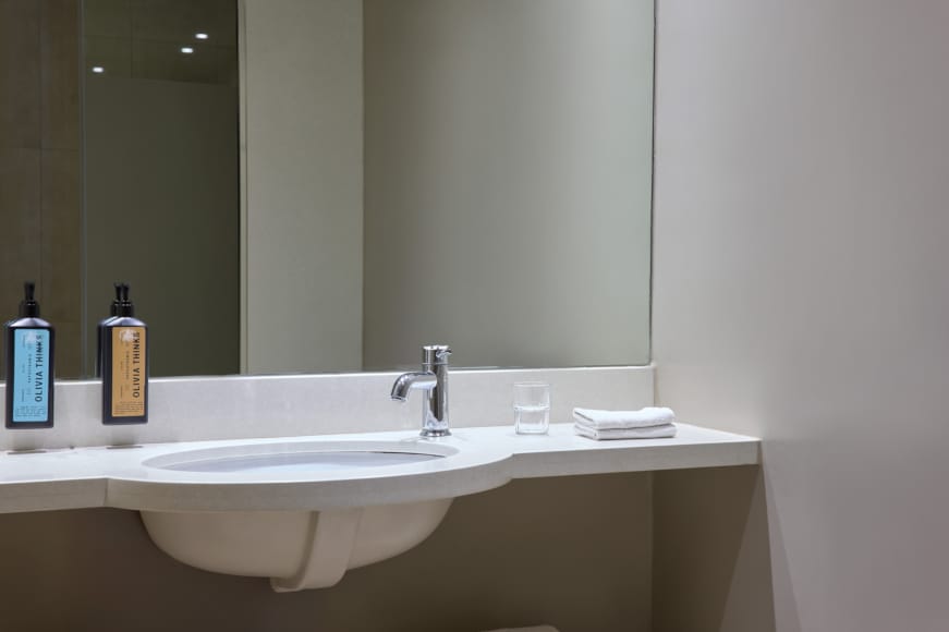 a bathroom with a sink and mirror