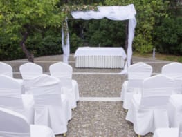 a group of white chairs outside