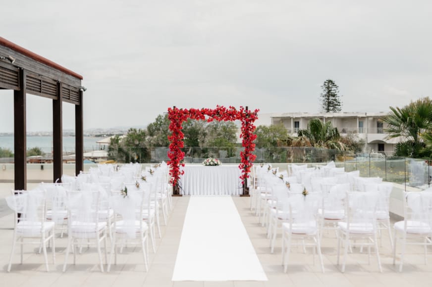 a group of white chairs and tables outside