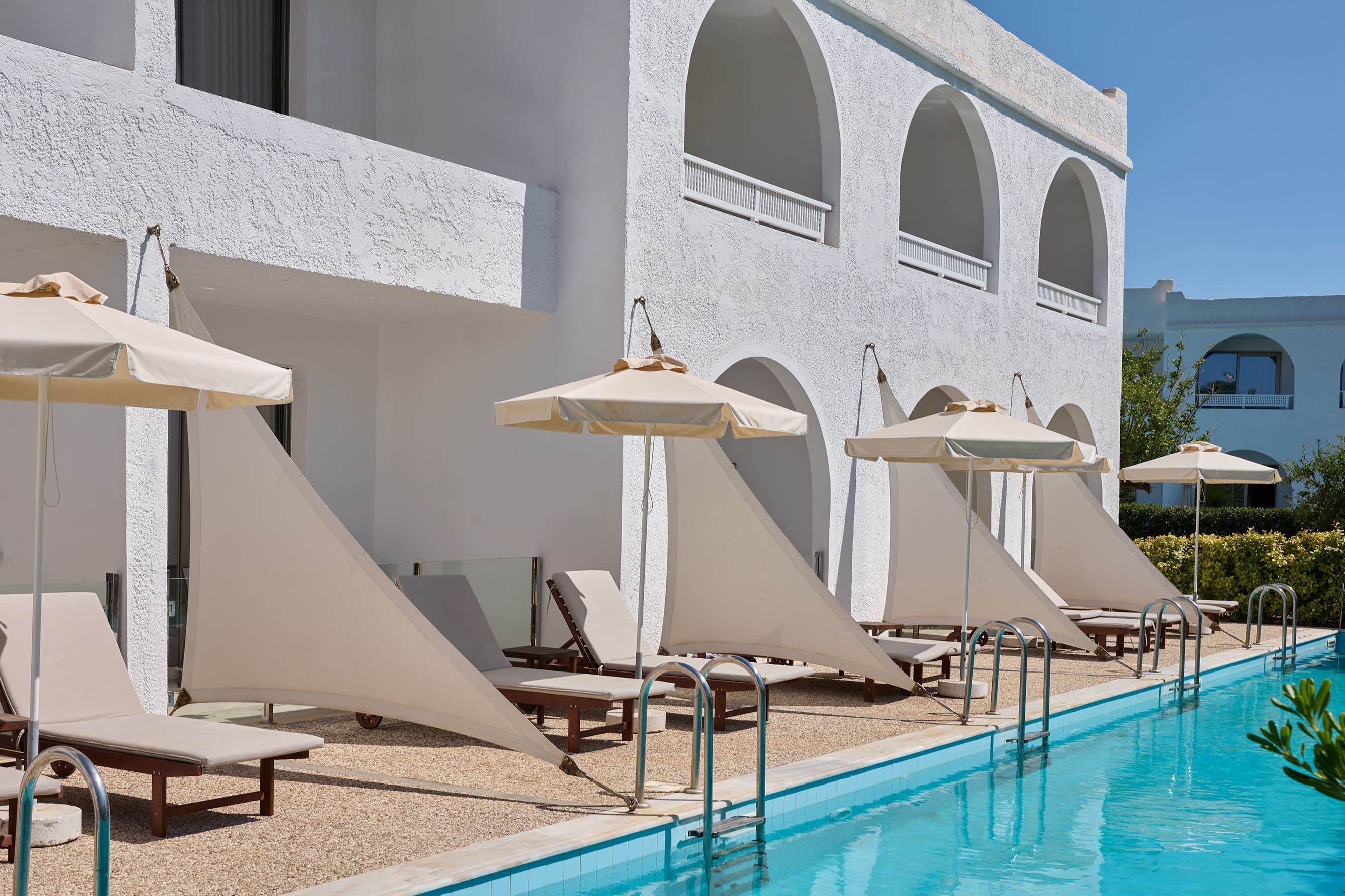 a pool with chairs and umbrellas