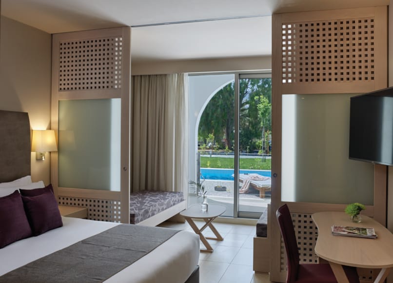a room with a pool and a large window