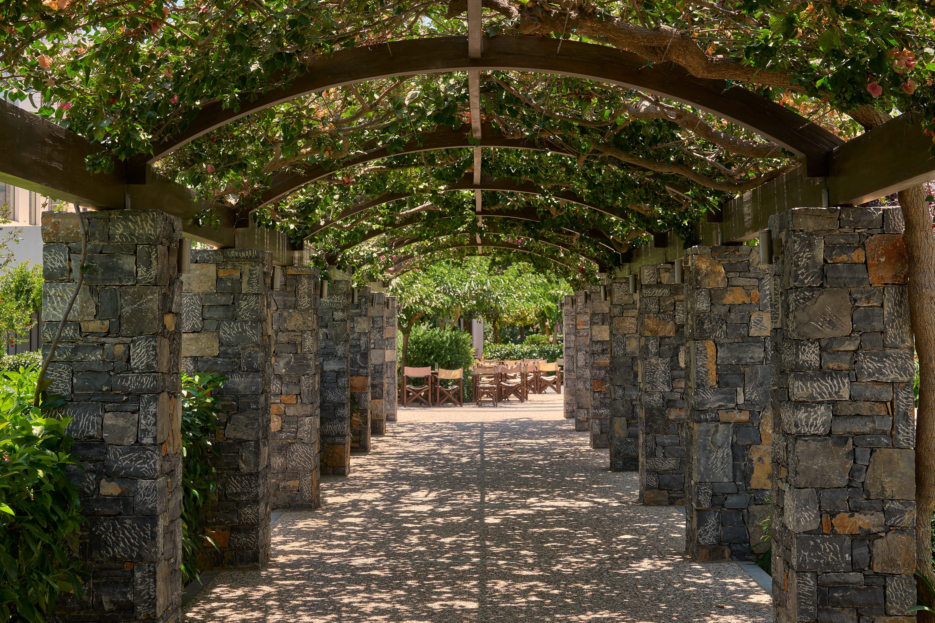 a stone walkway with a stone archway